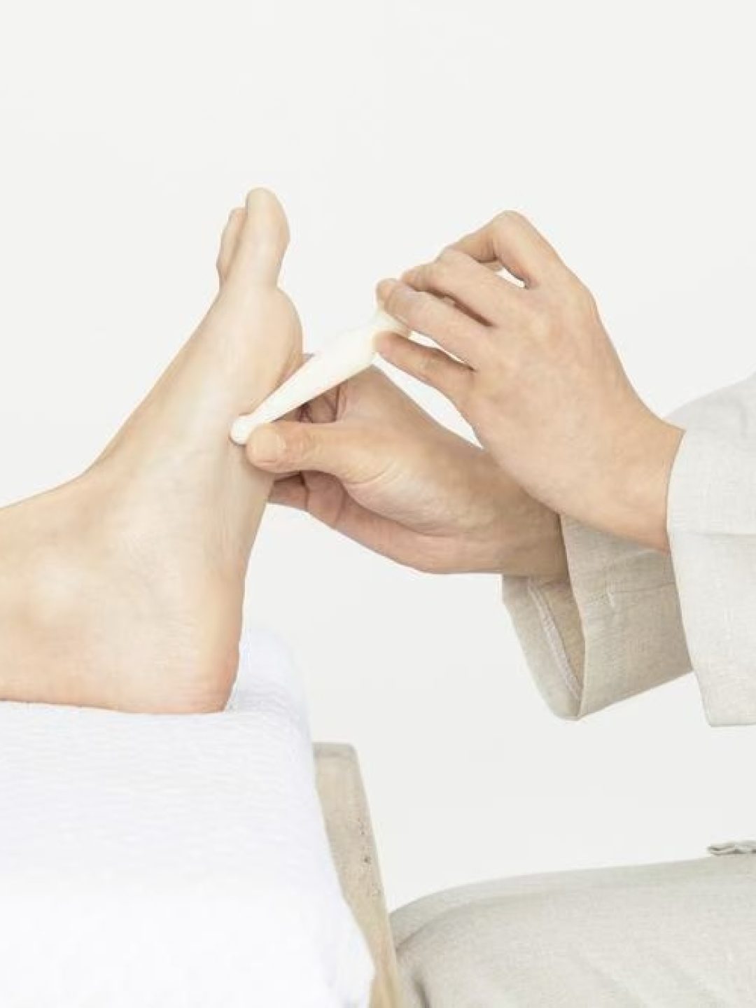 Foot acupressure massage targeting pressure points to improve circulation and relaxation.