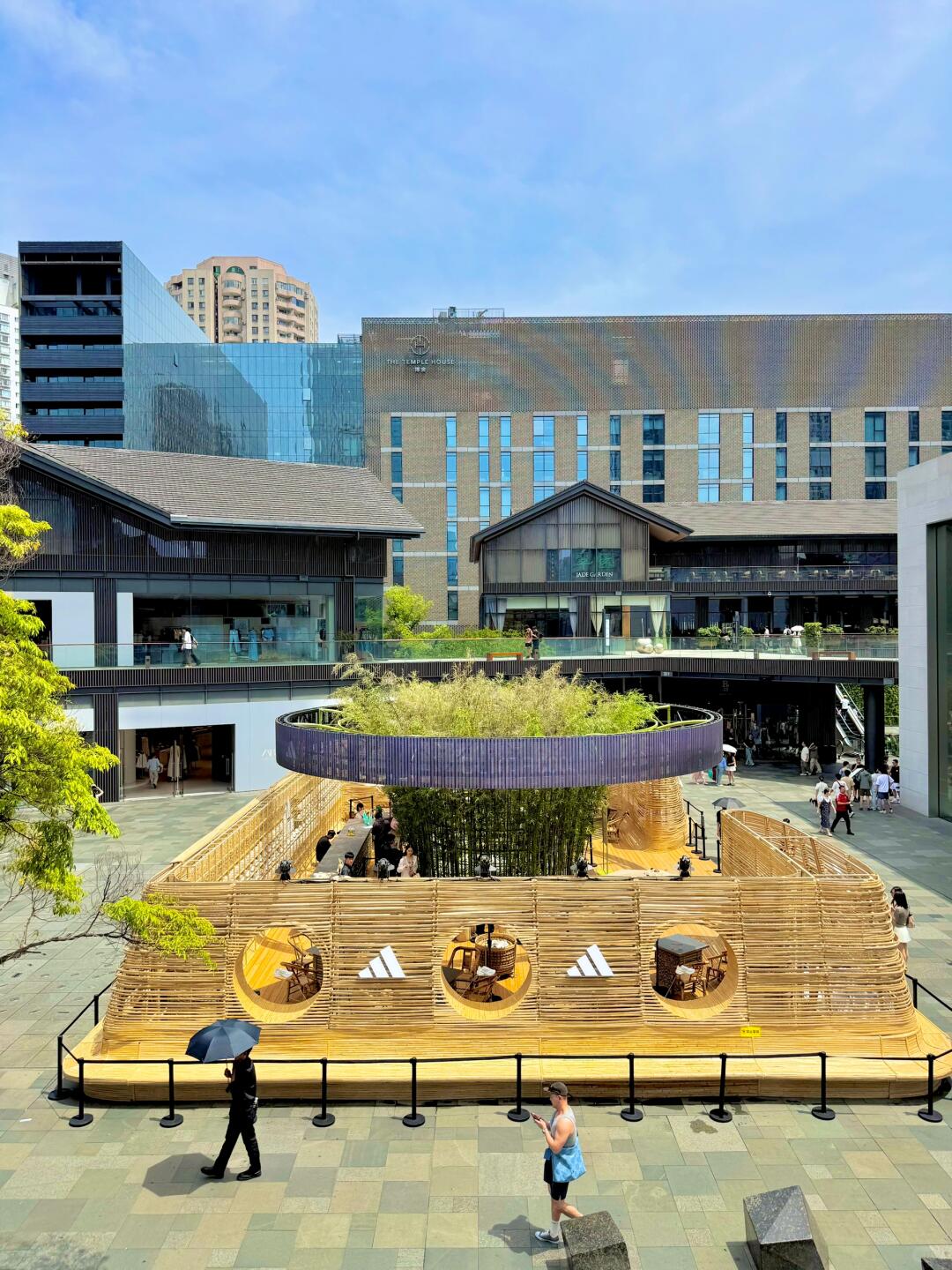 Modern open-air teahouse in central Chengdu with people drinking tea and relaxing in the sunshine, representing the city’s casual tea lifestyle.