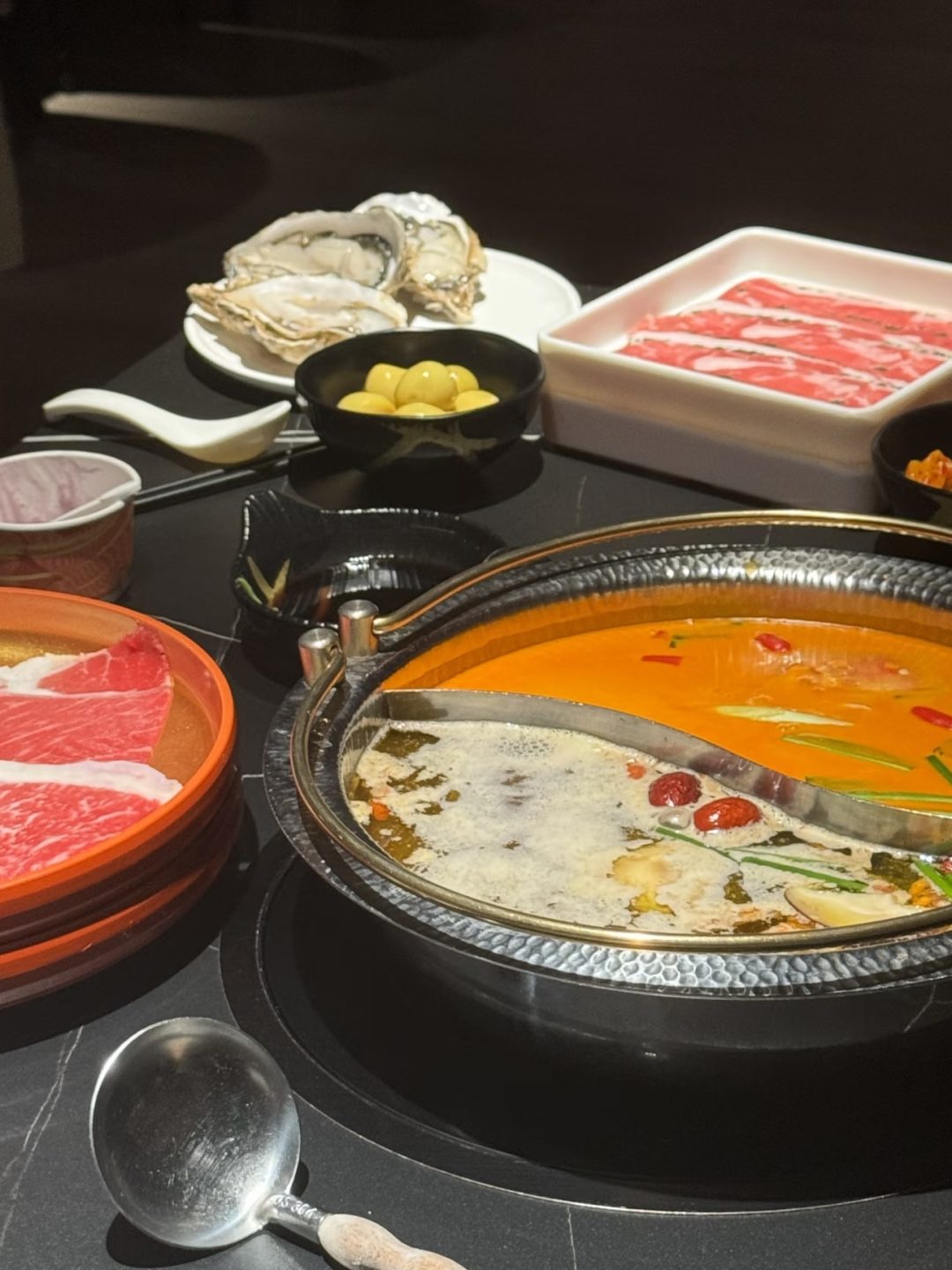Hot pot and side dishes served at FUFU Bathhouse as part of its extensive all-inclusive dining experience.