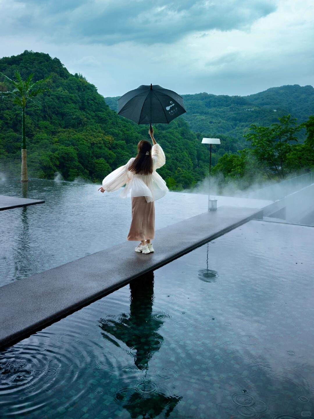 Mountain-view infinity pool at Qingxia Mountain Residence, featuring a reflective water surface perfect for photography.