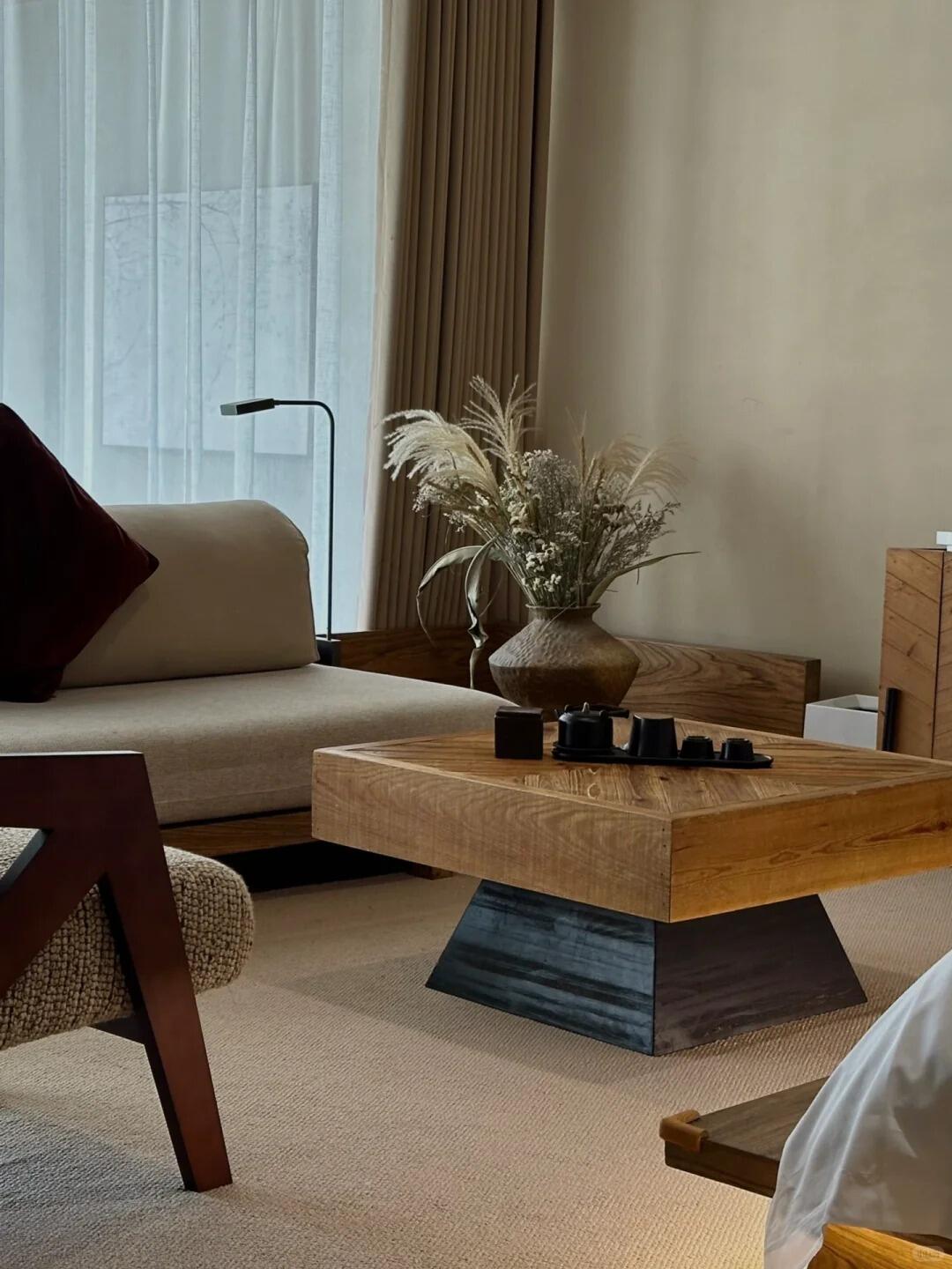 Interior detail at Rushi Qingchen Retreat showcasing natural wood furniture, soft lighting, and a serene minimalist aesthetic.