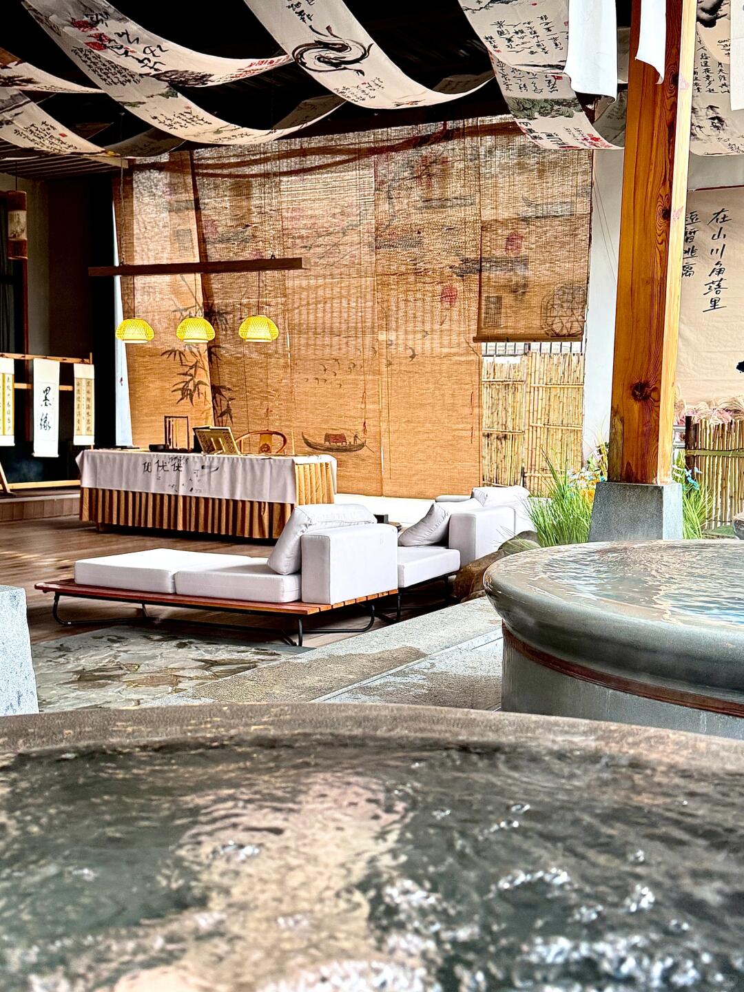 Outdoor hot spring pool and relaxed seating area at Tang Leyuan Hot Spring, showcasing its laid-back neighborhood atmosphere.