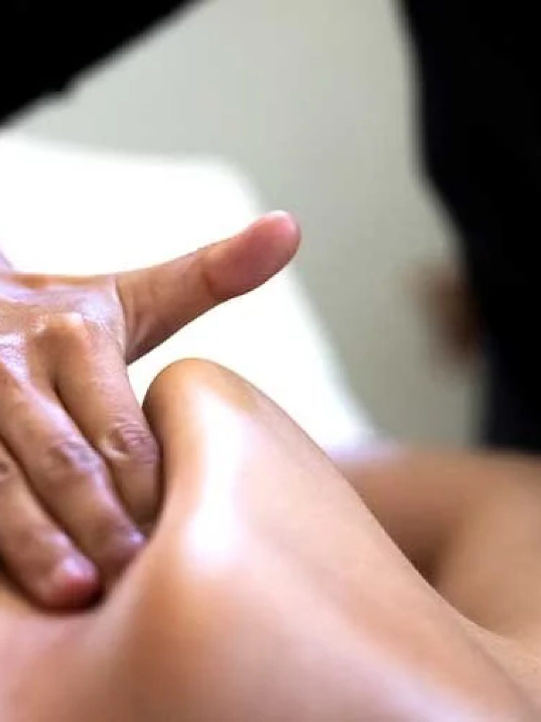 Close-up of Tuina massage techniques focusing on acupressure and muscle relief.