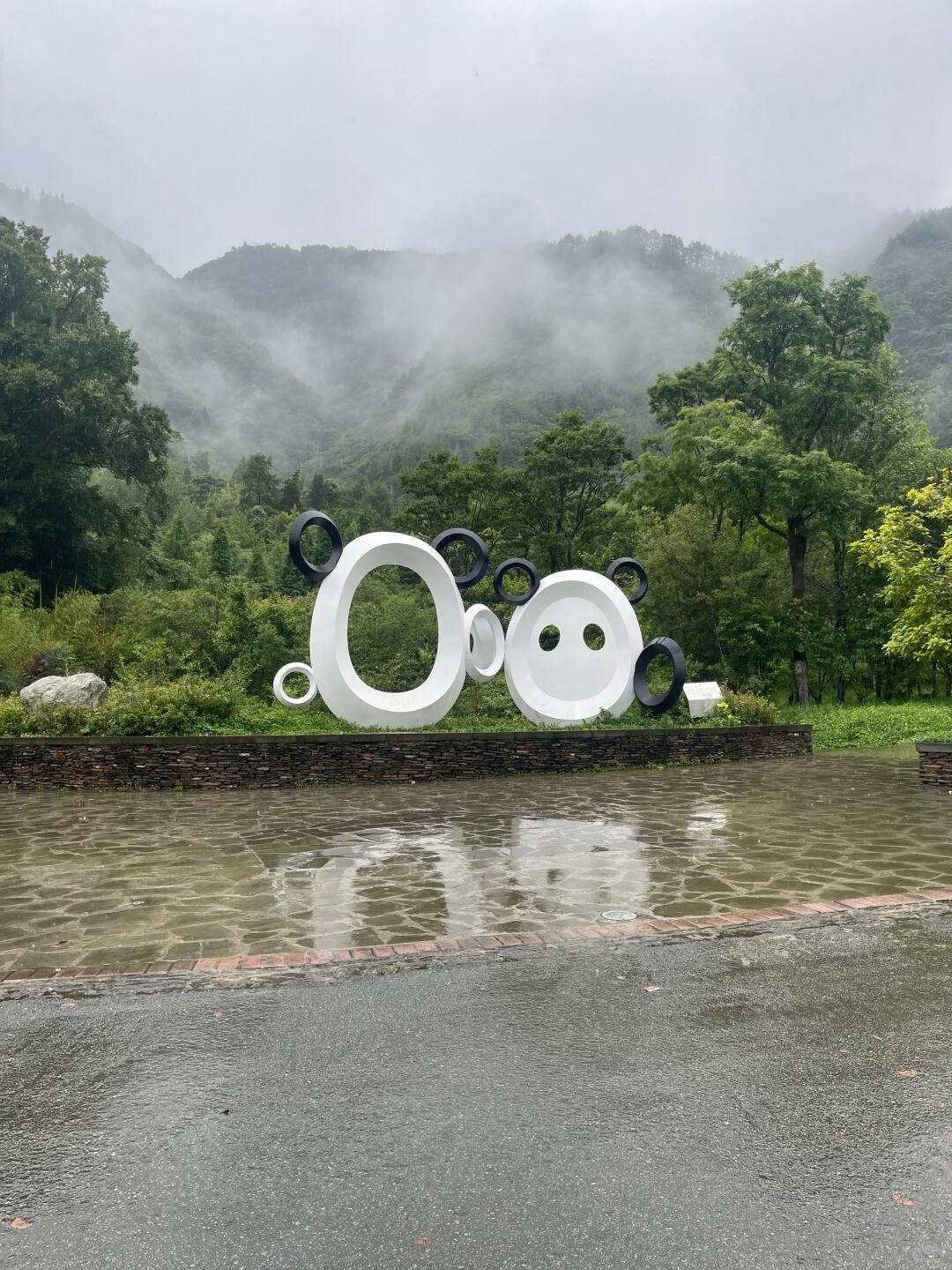 Mountain scenery and entrance area at Wolong Shenshuping Panda Base in Sichuan